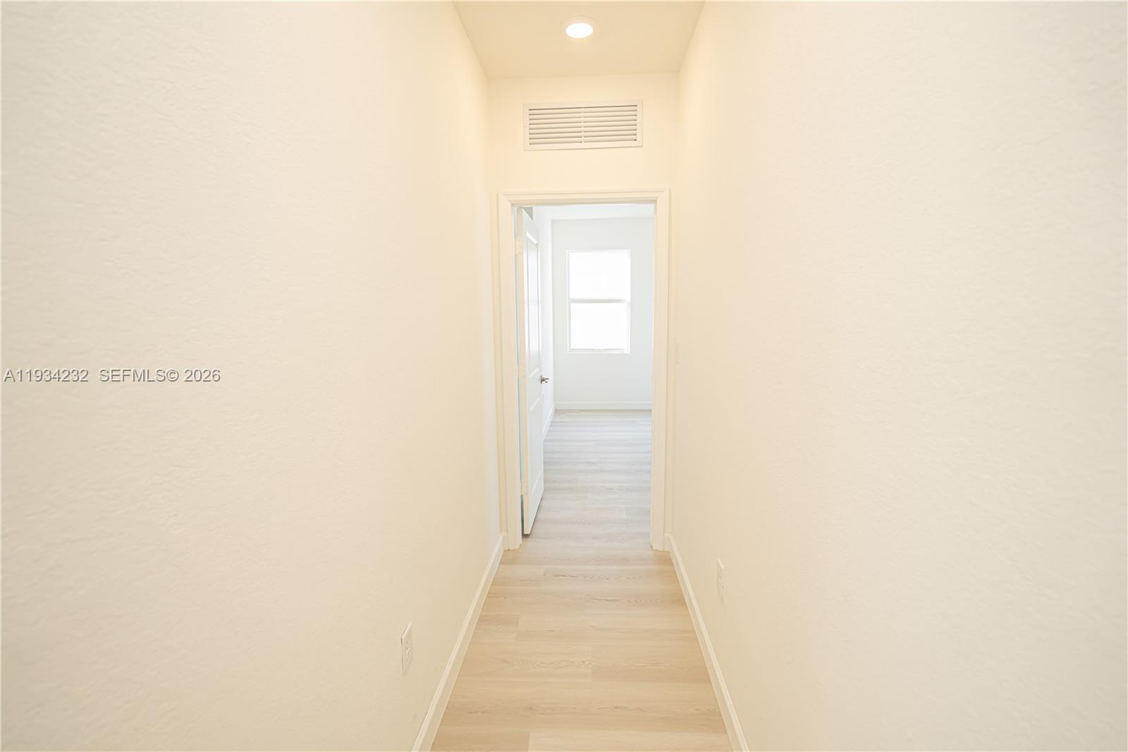 19507 Southwest 339th Terrace Homestead, FL 33034 - Photo 50 of 83 a hallway with wooden floor and a bathroom