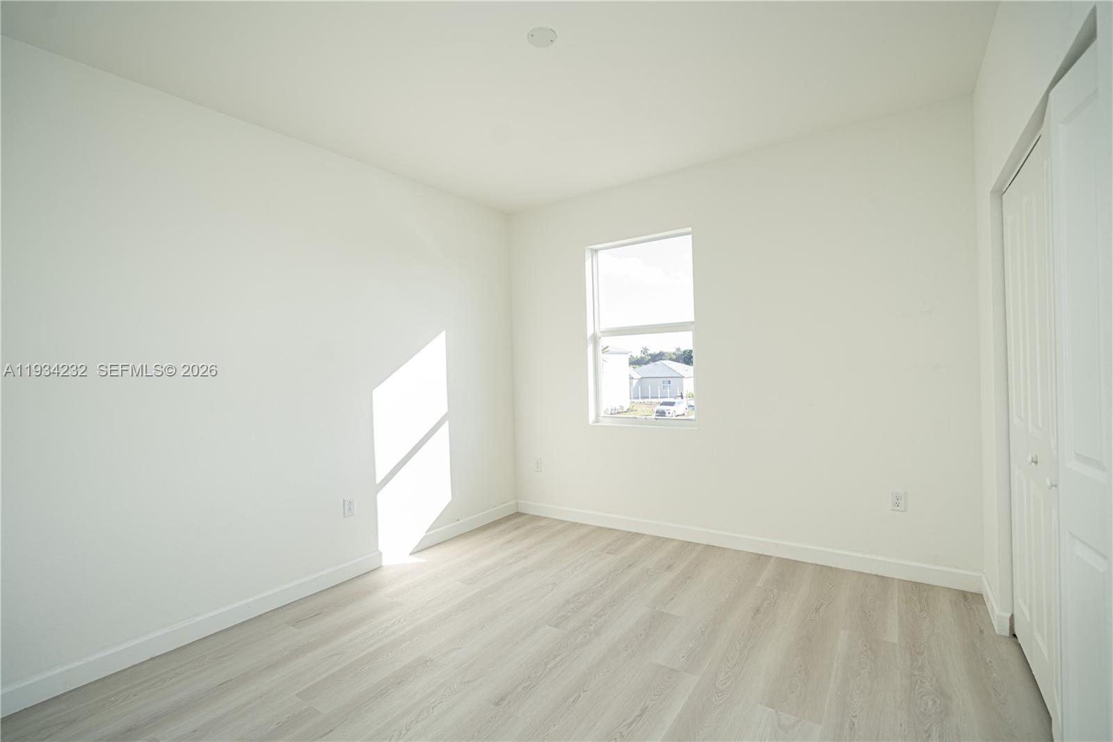 19507 Southwest 339th Terrace Homestead, FL 33034 - Photo 66 of 83 an empty room with wooden floor and windows