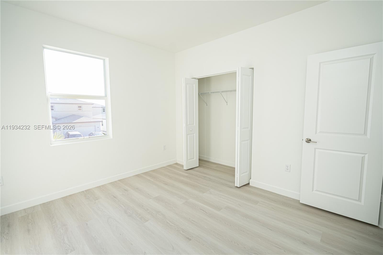 19507 Southwest 339th Terrace Homestead, FL 33034 - Photo 67 of 83 an empty room with wooden floor and windows
