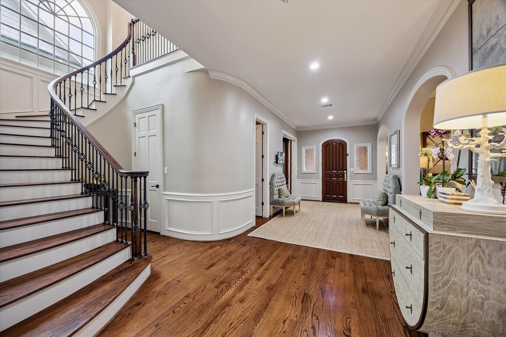 6358 Auden Street Houston, TX 77005 - Photo 18 of 50 Stairway as seen from entry into the family room. Door on curved wall is to a large IT and storage closet