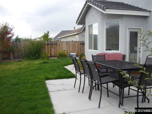1870 Cliffhanger Drive Reno, NV 89521 - Photo 4 of 4 a patio with a table and chairs and potted plants