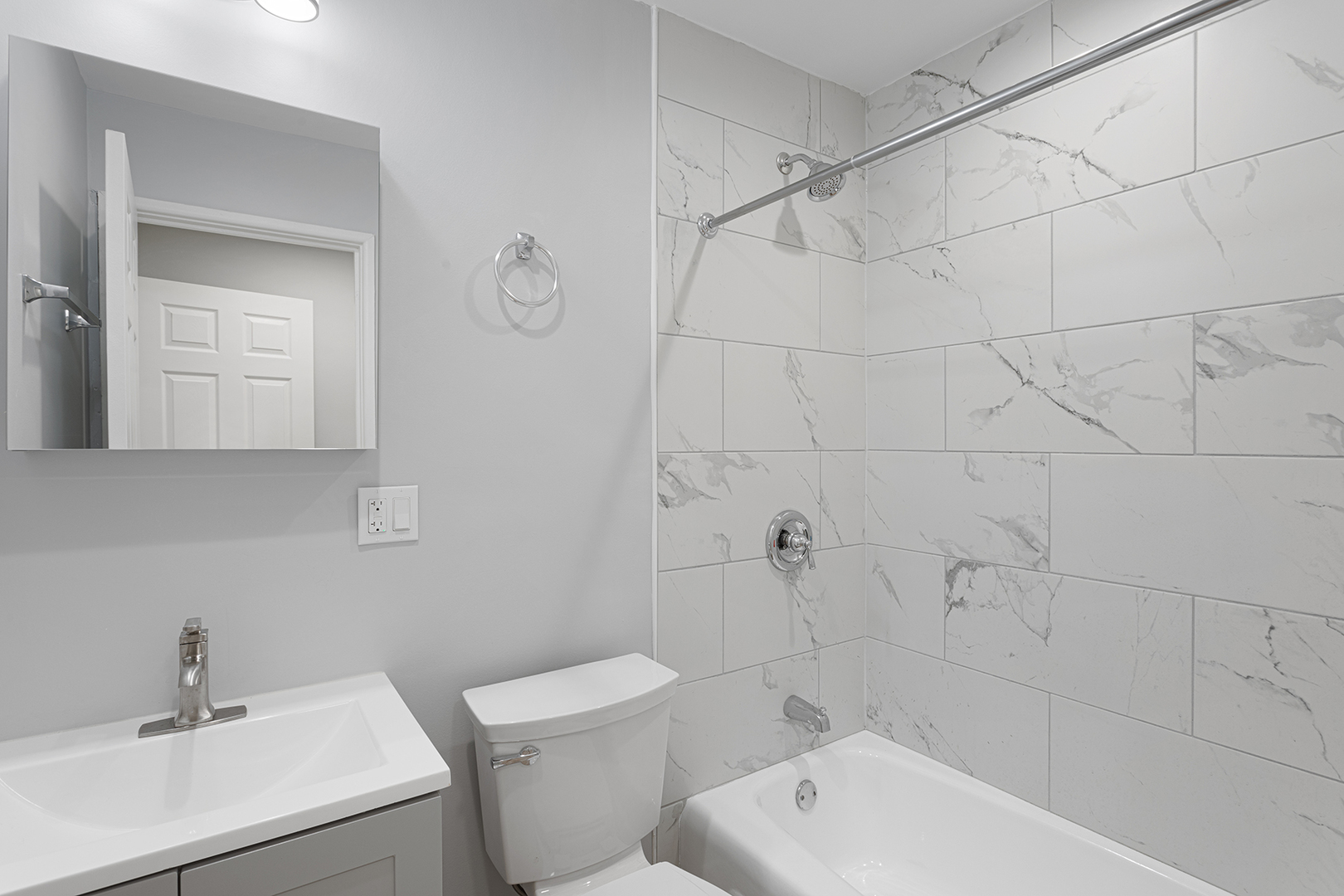 5534 North Kenmore Avenue, Unit 206 Chicago, IL 60640 - Photo 11 of 13 a bathroom with a toilet a sink a mirror and vanity