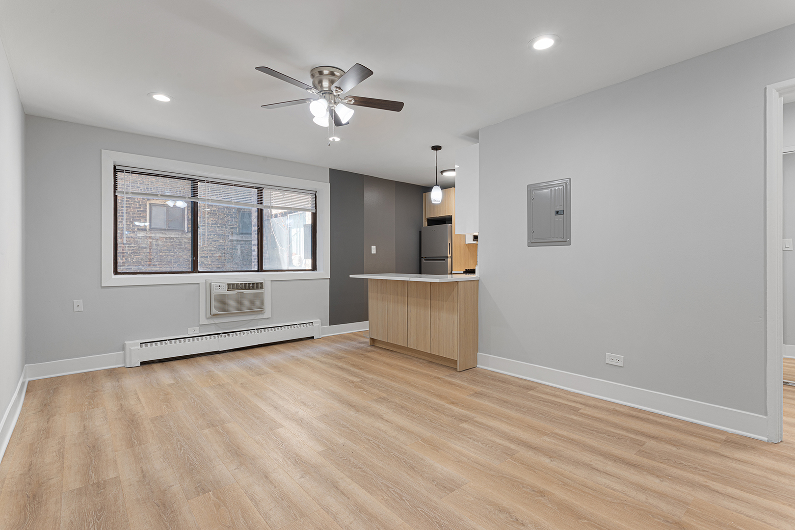 5534 North Kenmore Avenue, Unit 206 Chicago, IL 60640 - Photo 3 of 13 an empty room with wooden floor and windows
