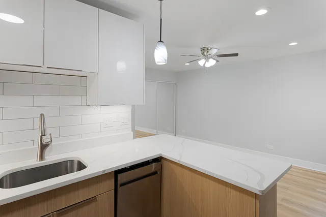 a kitchen with a sink and cabinets