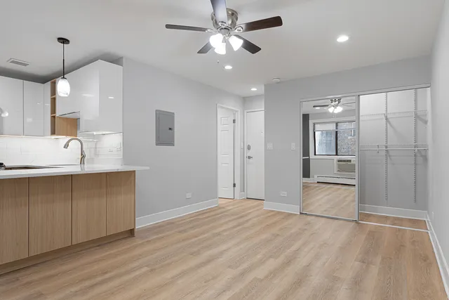 a view of a kitchen with a sink and a refrigerator