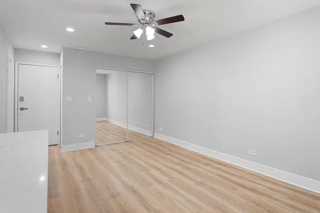 a bedroom with a bed and a ceiling fan