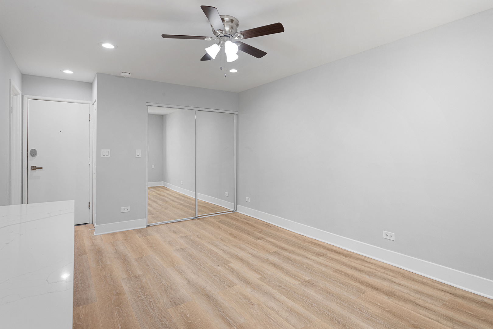 5534 North Kenmore Avenue, Unit 206 Chicago, IL 60640 - Photo 7 of 13 a bedroom with a bed and a ceiling fan