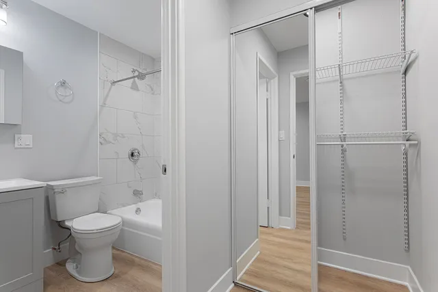 a bathroom with a toilet and a shower