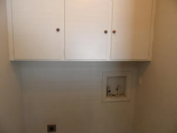 a bathroom with a shower and cabinets
