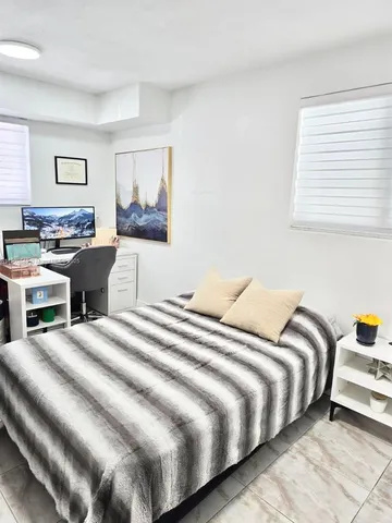 a bedroom with a bed and a couch