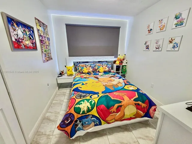 a bedroom with toys and dresser with a shoe rack
