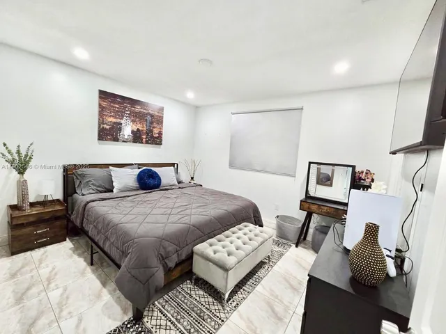 a bedroom with a bed and a couch