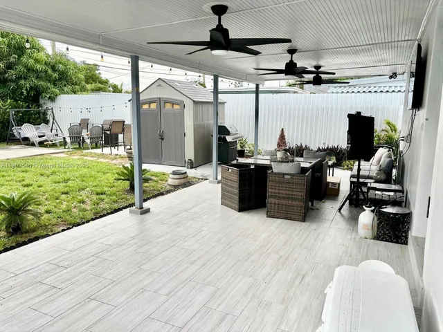 a view of a livingroom with wooden floor and a fireplace