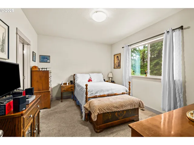 a bedroom with a bed and flat screen tv