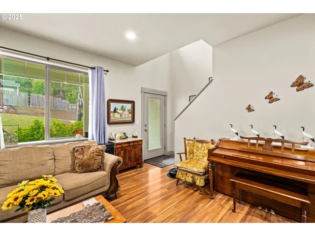 a living room with furniture and a piano