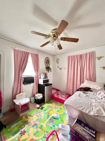 a view of a dining room and livingroom with furniture wooden floor and a chandelier
