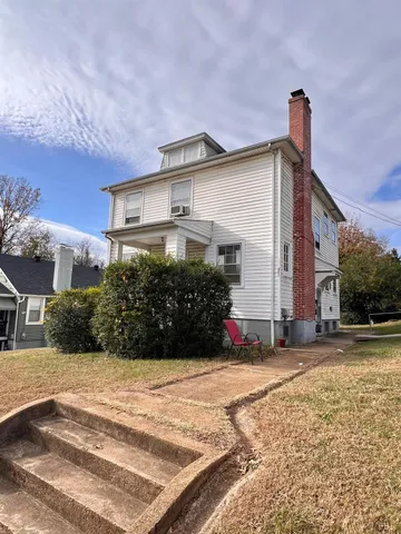 a view of a house with a yard and plants