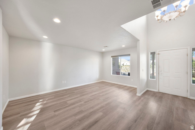 1440 West 100 South Virgin, UT 84779 - Photo 7 of 45 Entryway featuring a white paneled door with side lights, high ceilings, and a decorative chandelier