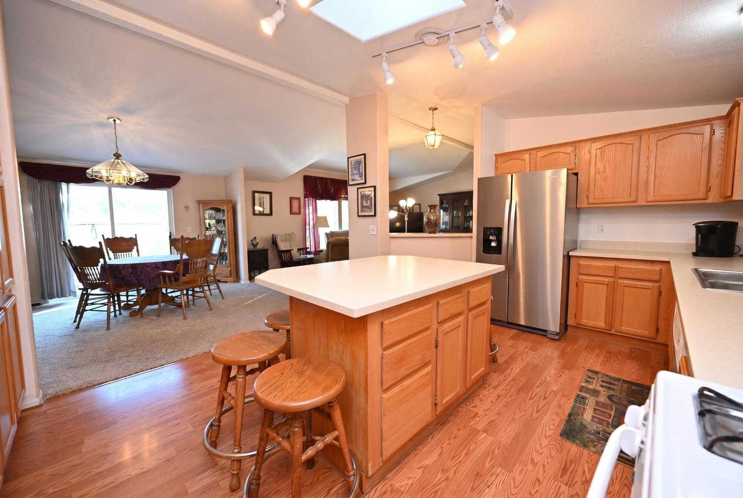 4360 Pleasant Valley Road Placerville, CA 95667 - Photo 44 of 71 a kitchen with a table chairs refrigerator and cabinets