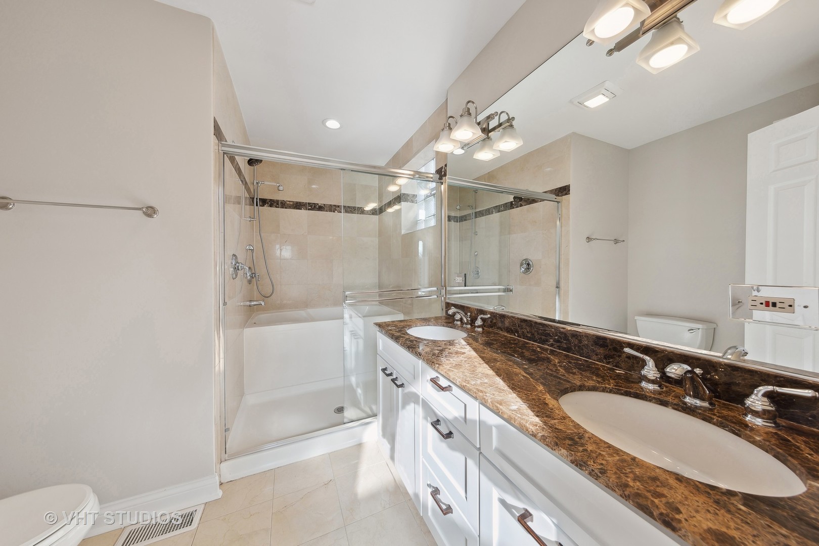 2031 West Augusta Boulevard, Unit 3 Chicago, IL 60622 - Photo 11 of 24 a bathroom with a granite countertop sink a toilet a mirror a vanity and shower