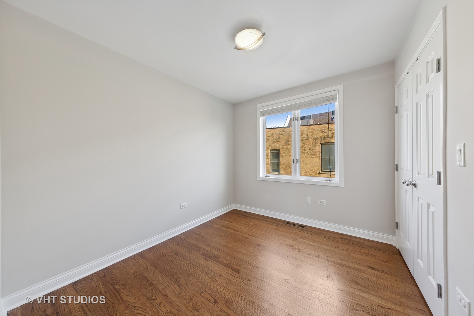 2031 West Augusta Boulevard, Unit 3 Chicago, IL 60622 - Photo 16 of 24 wooden floor in an empty room with a window
