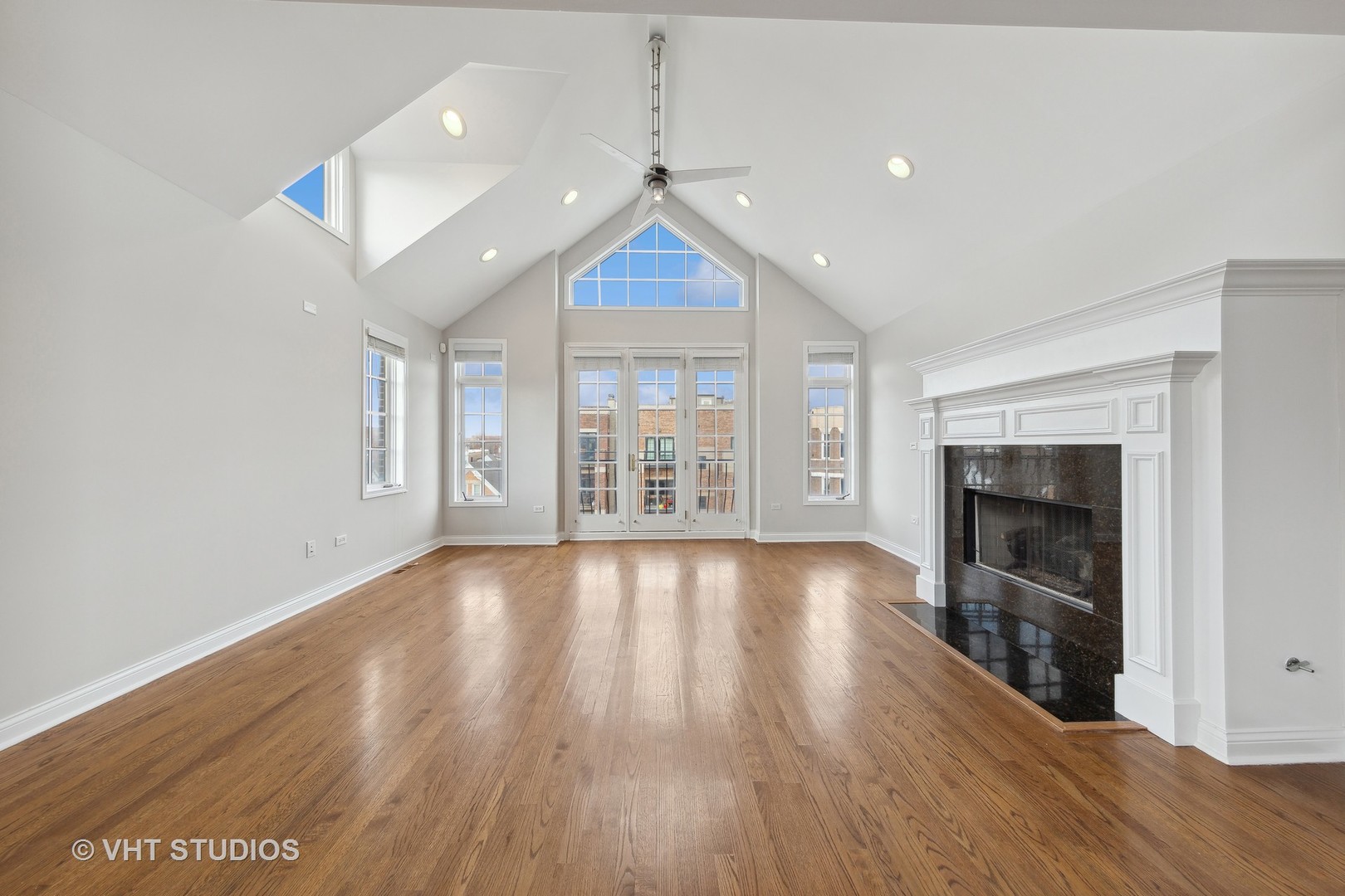 2031 West Augusta Boulevard, Unit 3 Chicago, IL 60622 - Photo 3 of 24 an empty room with wooden floor fireplace and windows