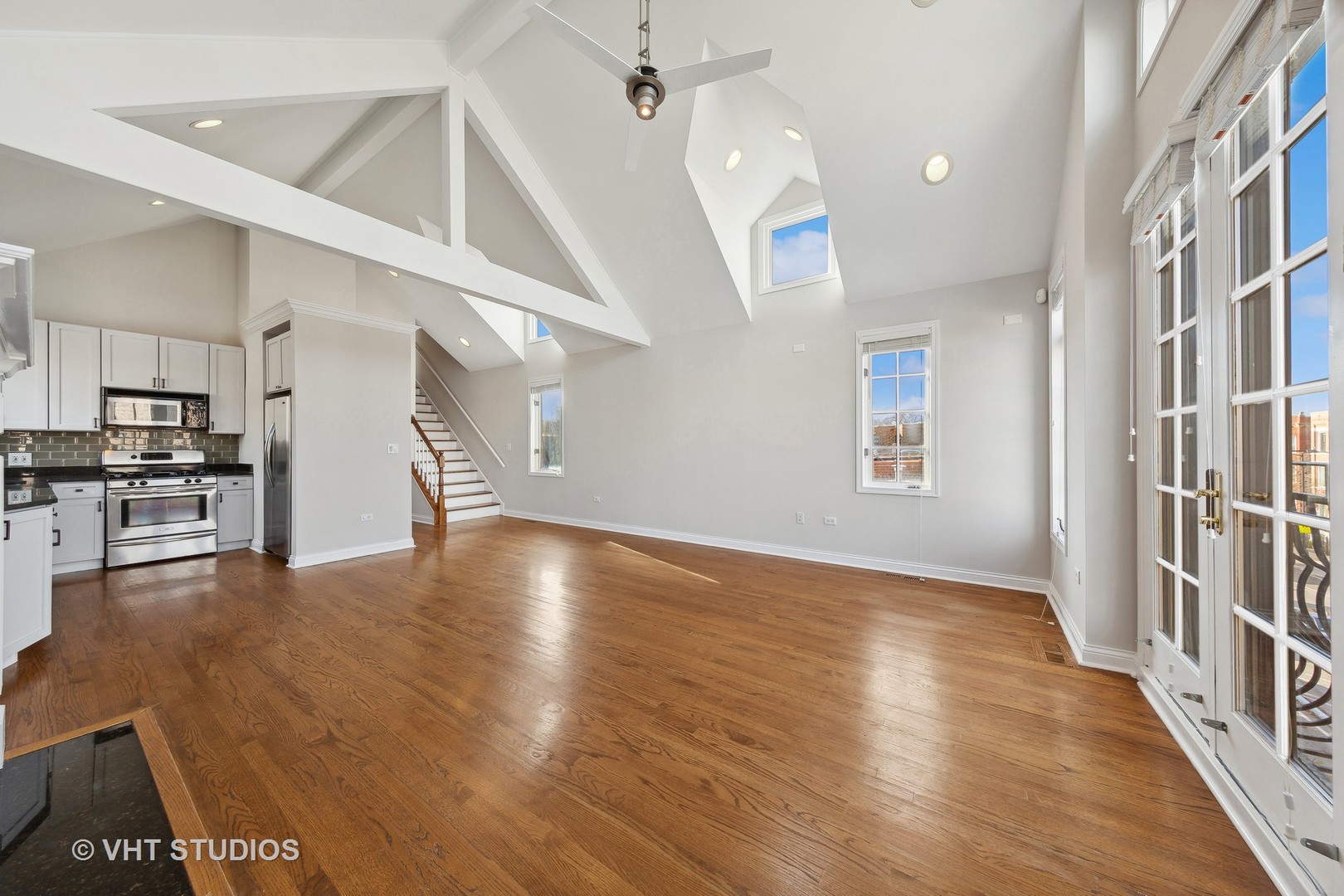 2031 West Augusta Boulevard, Unit 3 Chicago, IL 60622 - Photo 7 of 24 an empty room with wooden floor and kitchen view