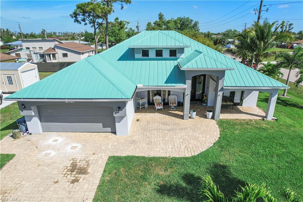 8081 Kansas Road Fort Myers, FL 33967 - Photo 1 of 21 a front view of a house with a yard and garage