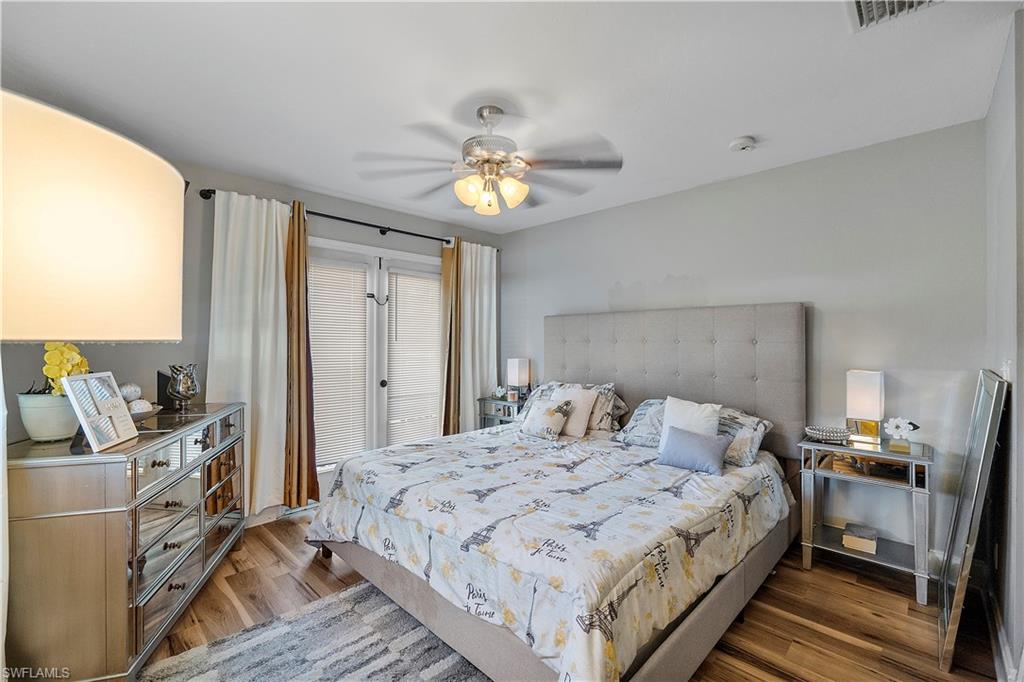 8081 Kansas Road Fort Myers, FL 33967 - Photo 19 of 21 a bedroom with a bed and a chandelier