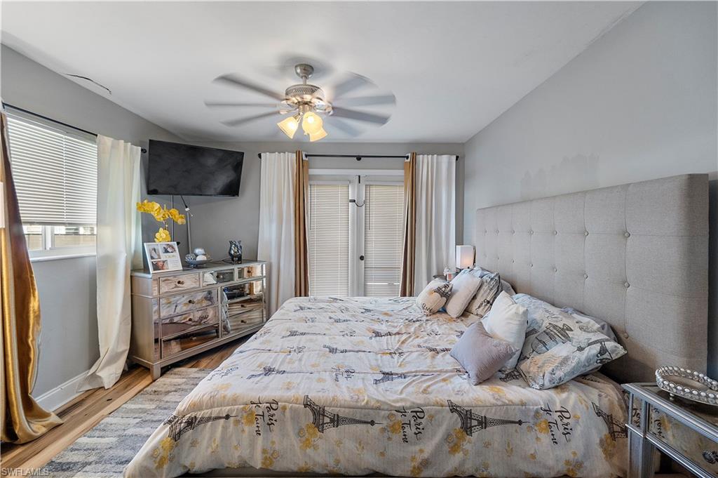 8081 Kansas Road Fort Myers, FL 33967 - Photo 20 of 21 a bedroom with a bed and a chandelier