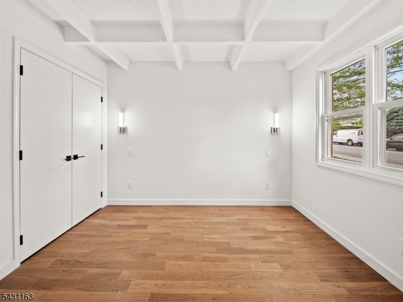 100 Chestnut Street, Unit 3 West Orange, NJ 07052 - Photo 15 of 18 wooden floor in an empty room with a window