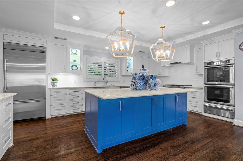 5831 Gramercy Place Dallas, TX 75230 - Photo 1 of 1 a kitchen with stainless steel appliances granite countertop a stove refrigerator and microwave