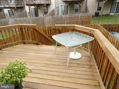 a view of a roof deck with chair and table