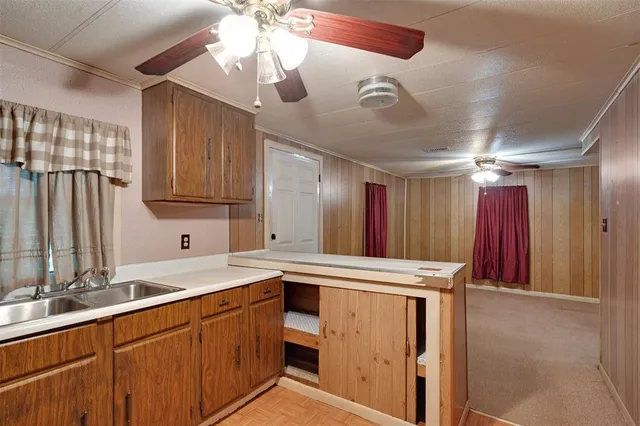 a kitchen with stainless steel appliances kitchen island granite countertop a sink and cabinets