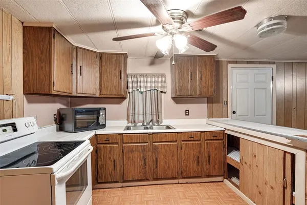 a kitchen with a sink a stove and cabinets