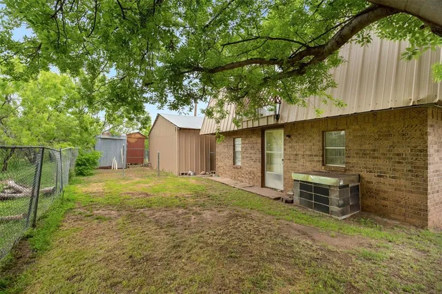 a backyard of a house with table and chairs