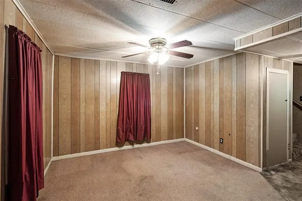a view of a hallway with a chandelier fan and stairs
