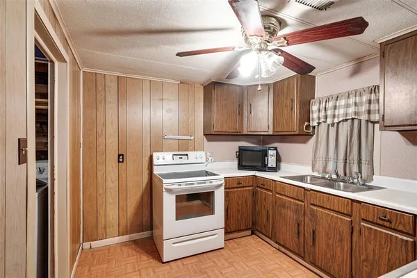 a kitchen with a stove cabinets and a sink