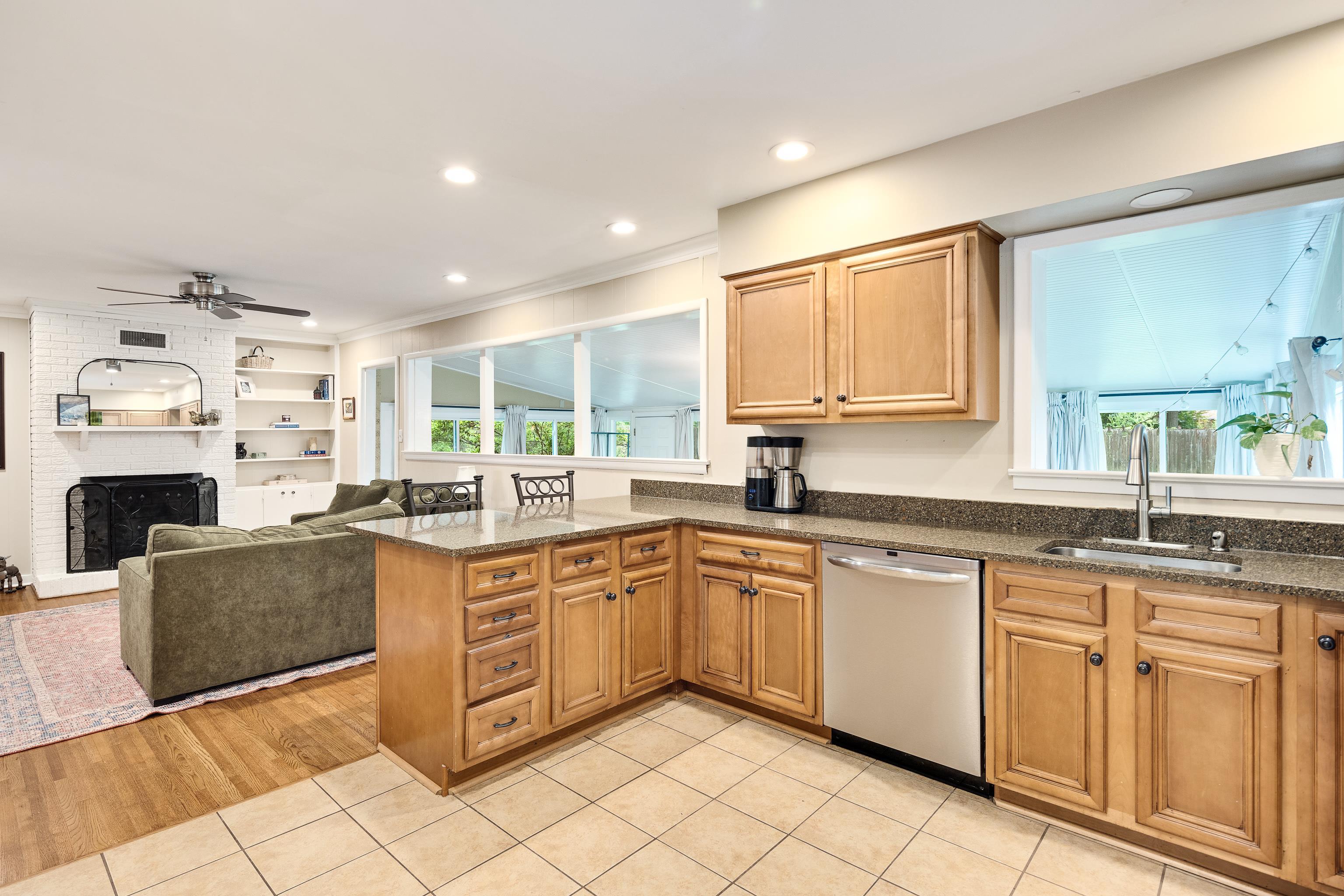 4152 Barfield Road Memphis, TN 38117 - Photo 20 of 37 Kitchen featuring a peninsula, dark stone countertops, stainless steel dishwasher, light tile patterned floors, and recessed lighting