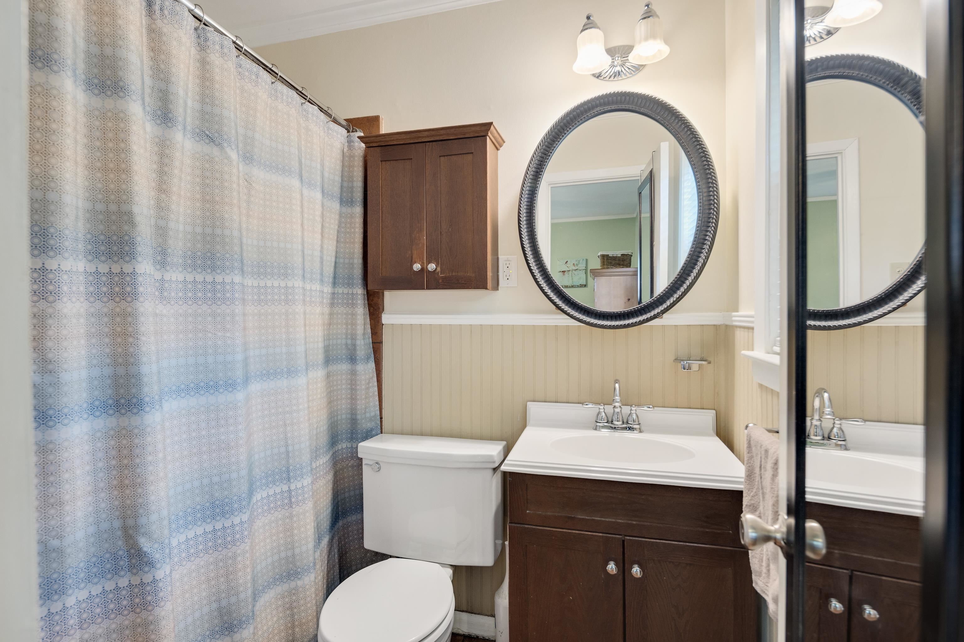 4152 Barfield Road Memphis, TN 38117 - Photo 23 of 37 Full bath with vanity, a wainscoted wall, a shower with curtain, and ornamental molding