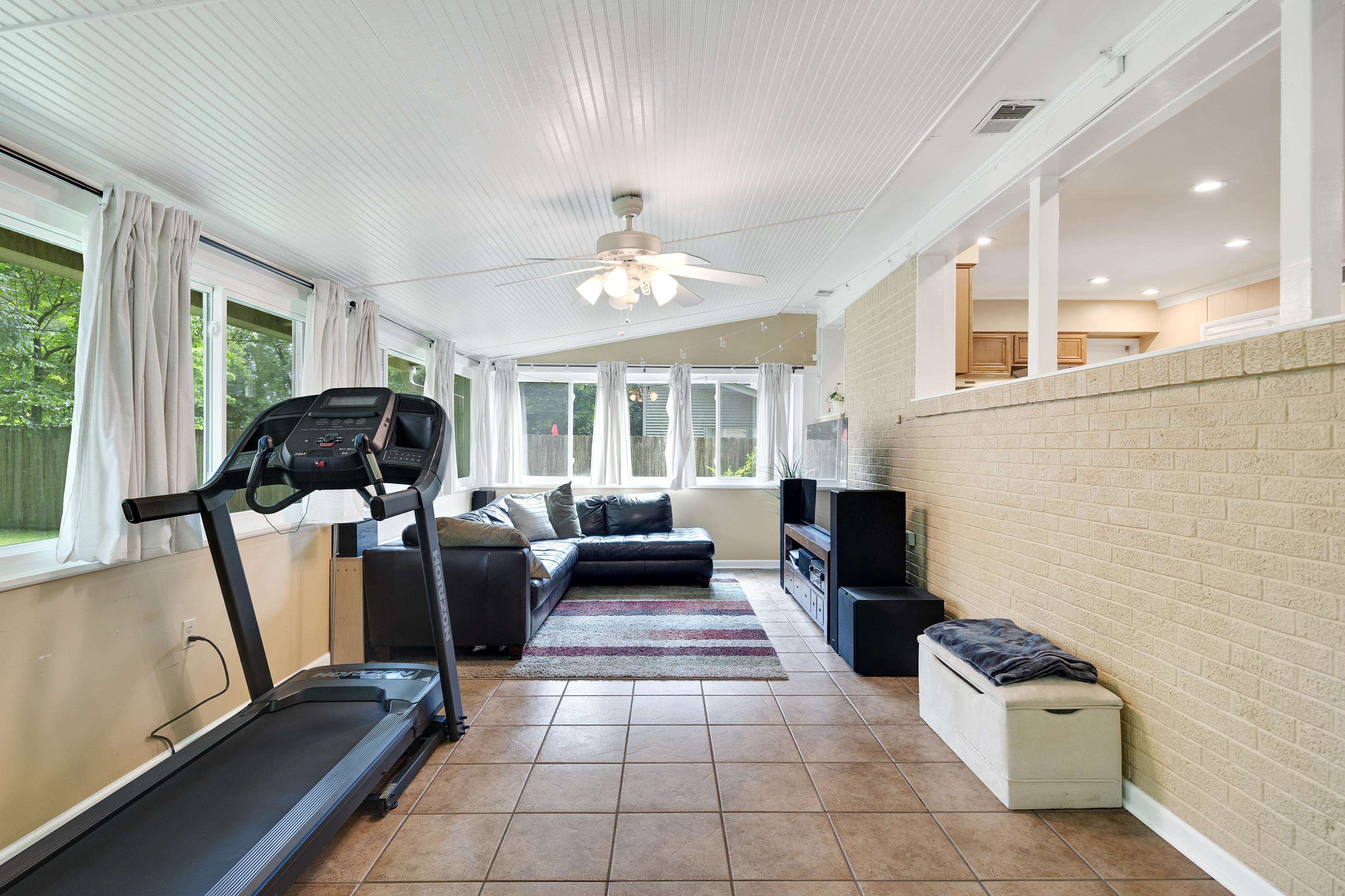 4152 Barfield Road Memphis, TN 38117 - Photo 31 of 37 Workout room with brick wall, light tile patterned flooring, vaulted ceiling, and ceiling fan