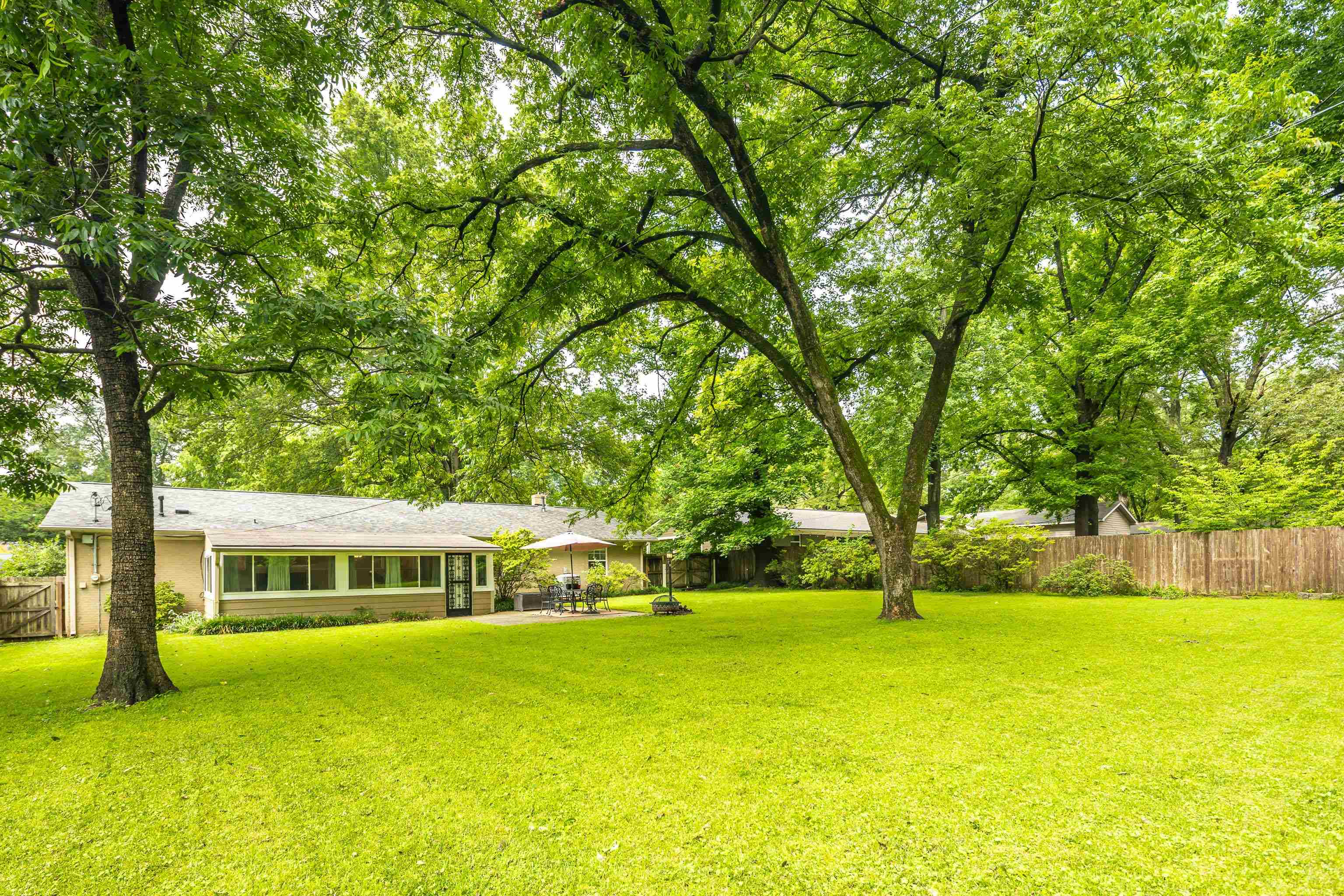 4152 Barfield Road Memphis, TN 38117 - Photo 34 of 37 Fenced backyard featuring a sunroom and view of scattered trees