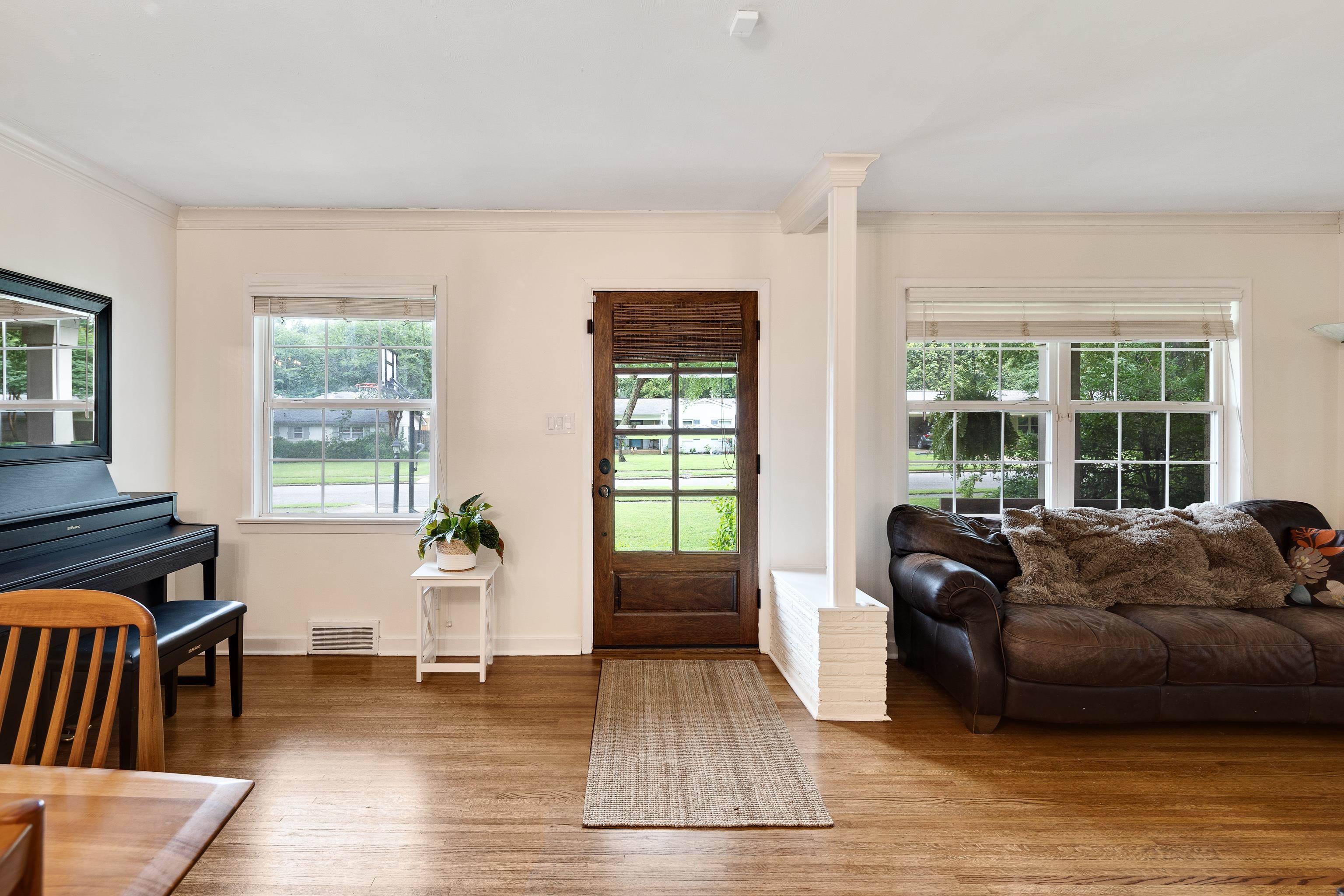 Foyer entrance with ornamental molding and wood finished floors