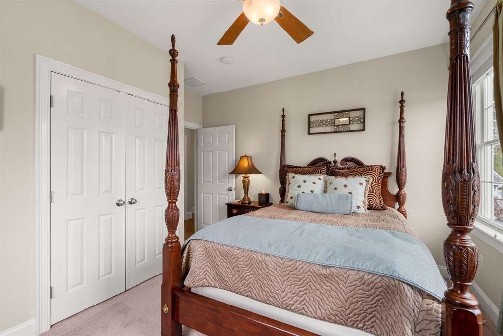 4 Point Shore Overlook Amesbury, MA 01913 - Photo 25 of 42 a bedroom with a bed and a chandelier