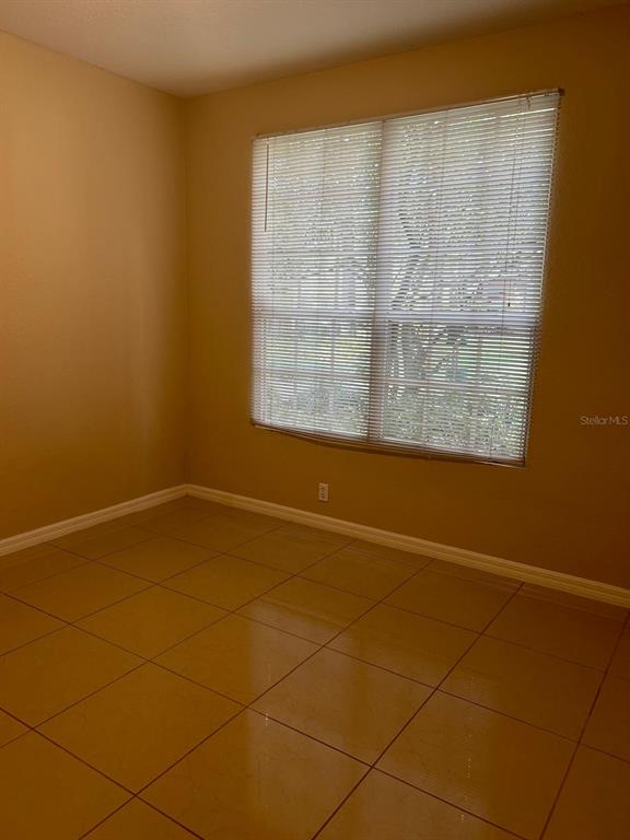 6408 Raleigh Street, Unit 2403 Orlando, FL 32835 - Photo 7 of 18 a view of an empty room with a window