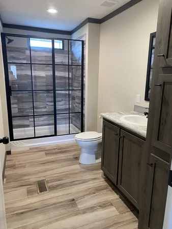 a bathroom with a sink toilet and shower