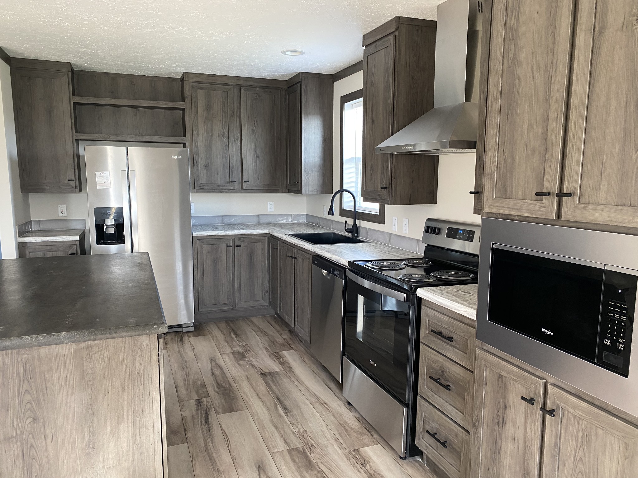 1646 Gamaliel Road Red Boiling Springs, TN 37150 - Photo 7 of 24 a kitchen with stainless steel appliances granite countertop a stove a sink and a refrigerator