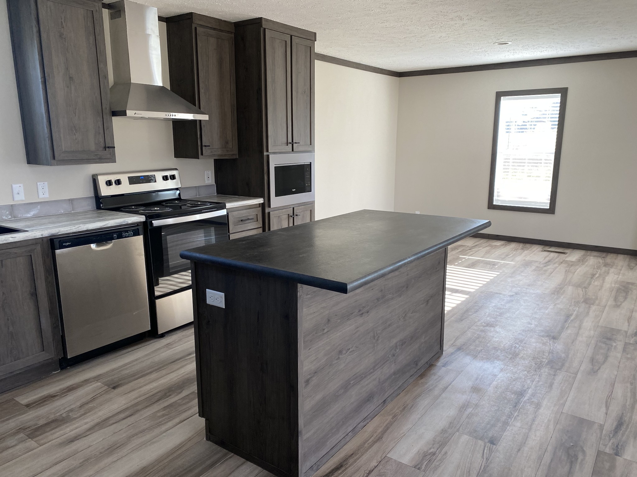 1646 Gamaliel Road Red Boiling Springs, TN 37150 - Photo 10 of 24 a kitchen with kitchen island granite countertop a sink cabinets and wooden floor