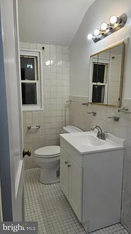 a bathroom with a sink a toilet and mirror