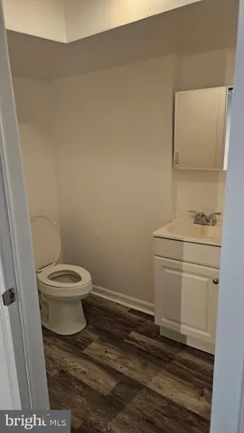 a bathroom with a toilet a sink and a window
